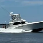 45’ Hatteras Convertible sportfishing yacht “Third Wish” with CAT diesels, shown docked with flybridge, fighting chair.