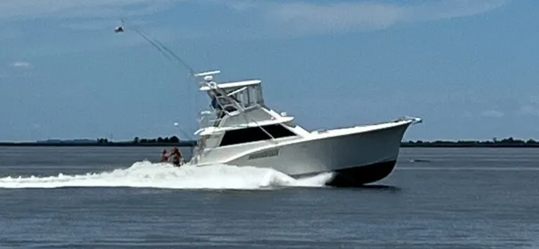 45’ Hatteras Convertible sportfishing yacht “Third Wish” with CAT diesels, shown docked with flybridge, fighting chair.